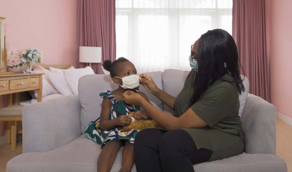 child putting on a mask