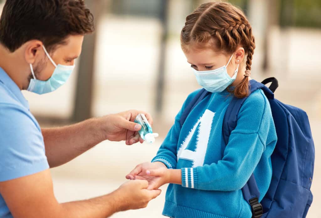 child using hand sanitizer