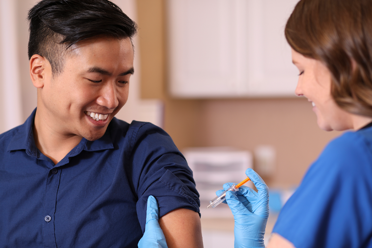 image of someone getting vaccinated by a professional with gloves